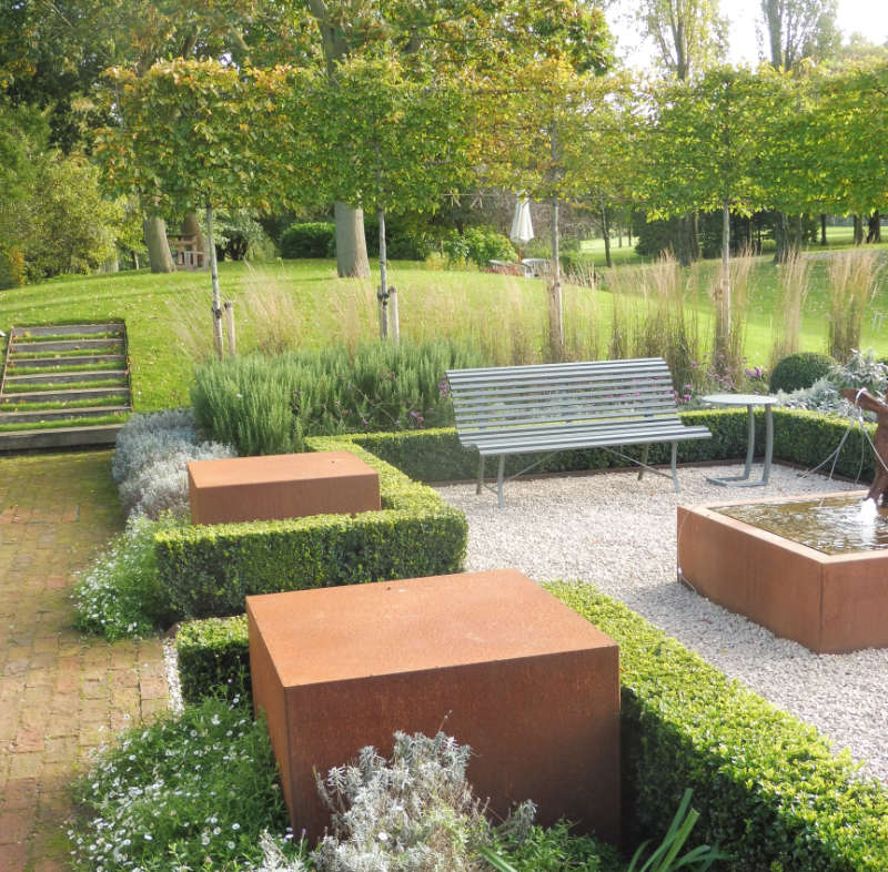 Seating area with steel cubes, Mediterranean style planting and 